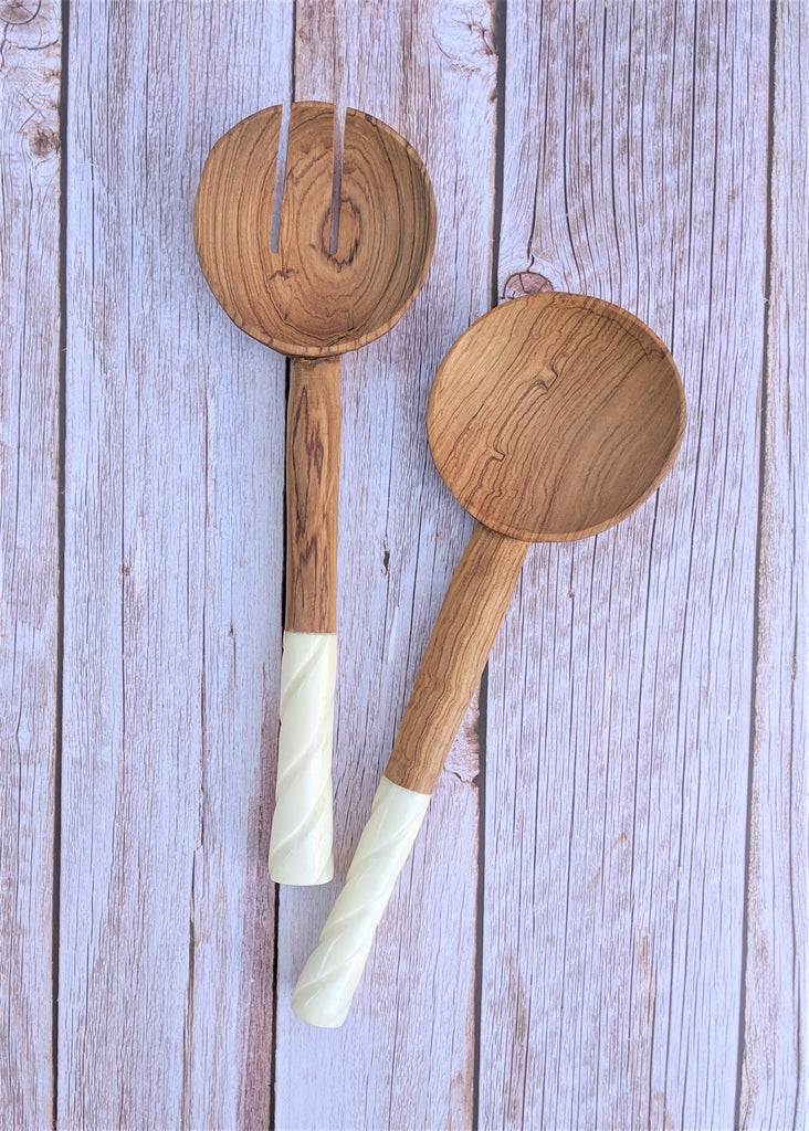 A pair of wood salad servers with white bone handles